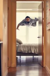 Man floating over a bed